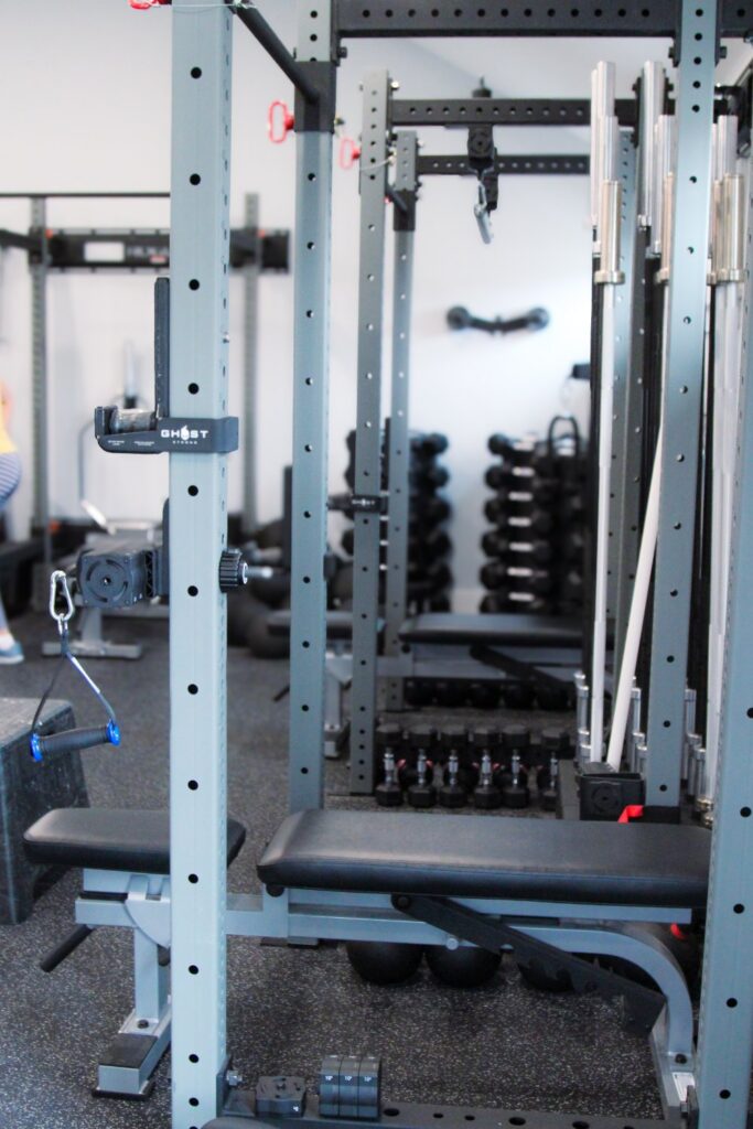 Ghost Workout Machines with dumbbell rack in the background