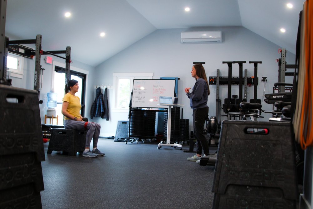 A Personal Trainer Coaching a client on the use of bands